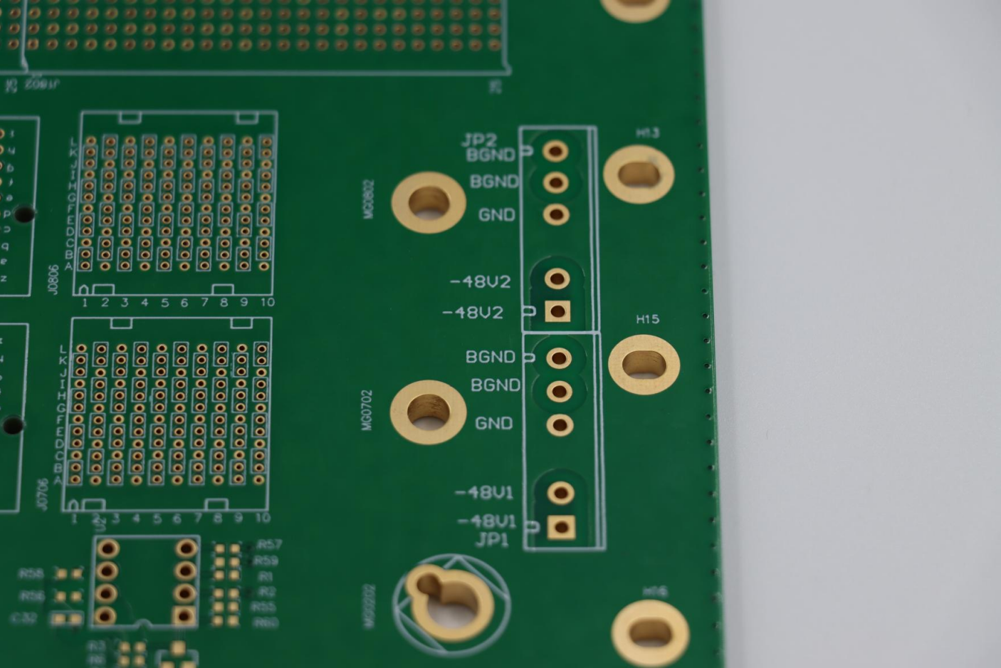 Close-up view of a printed circuit board (PCB) showing copper traces, and pads, highlighting the detailed layout of electronic connections.