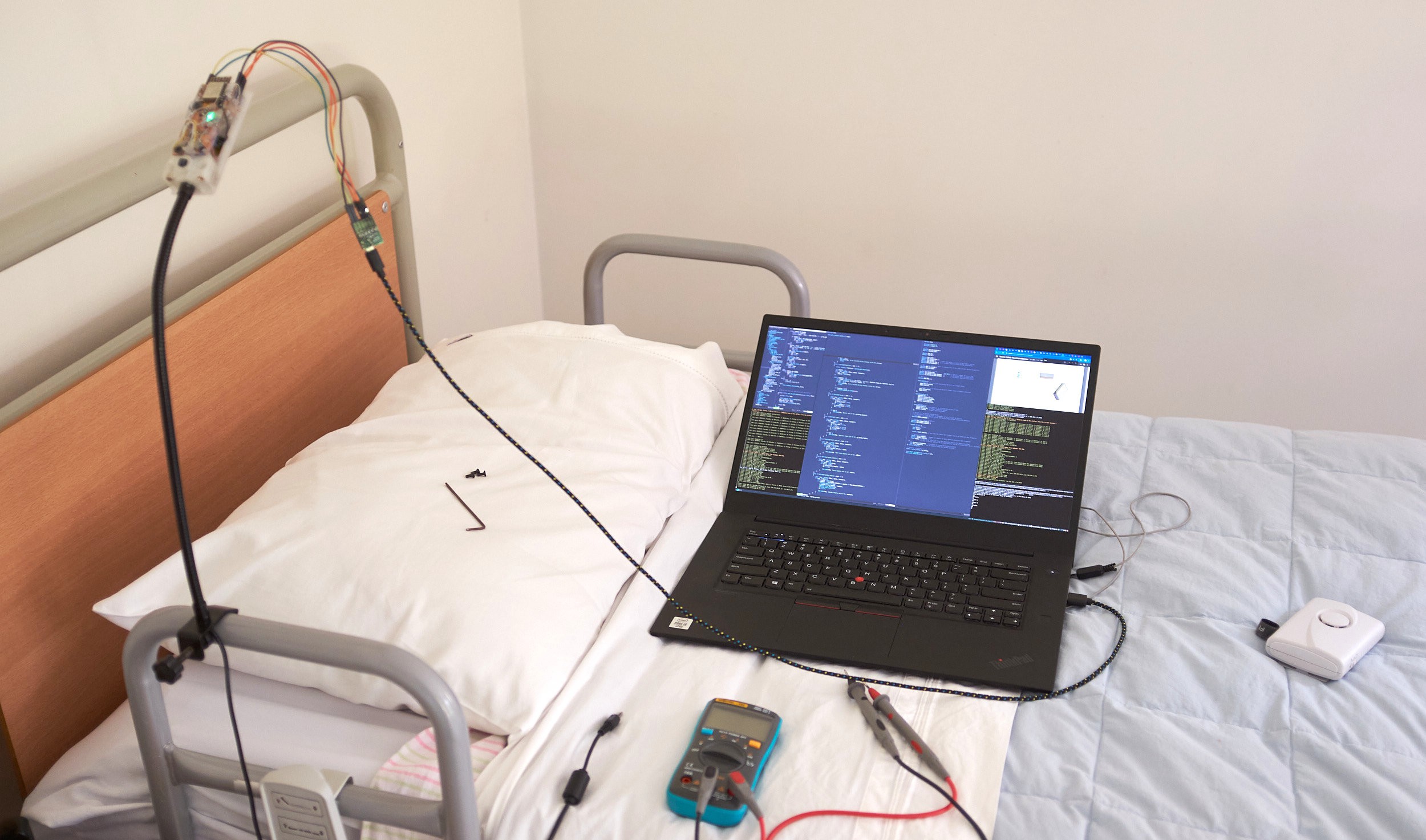 Motion sensor device on medical bed with development laptop Motion sensor device on medical bed with development laptop