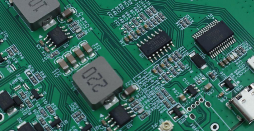 PCB circuit board section with copper traces and electronic components