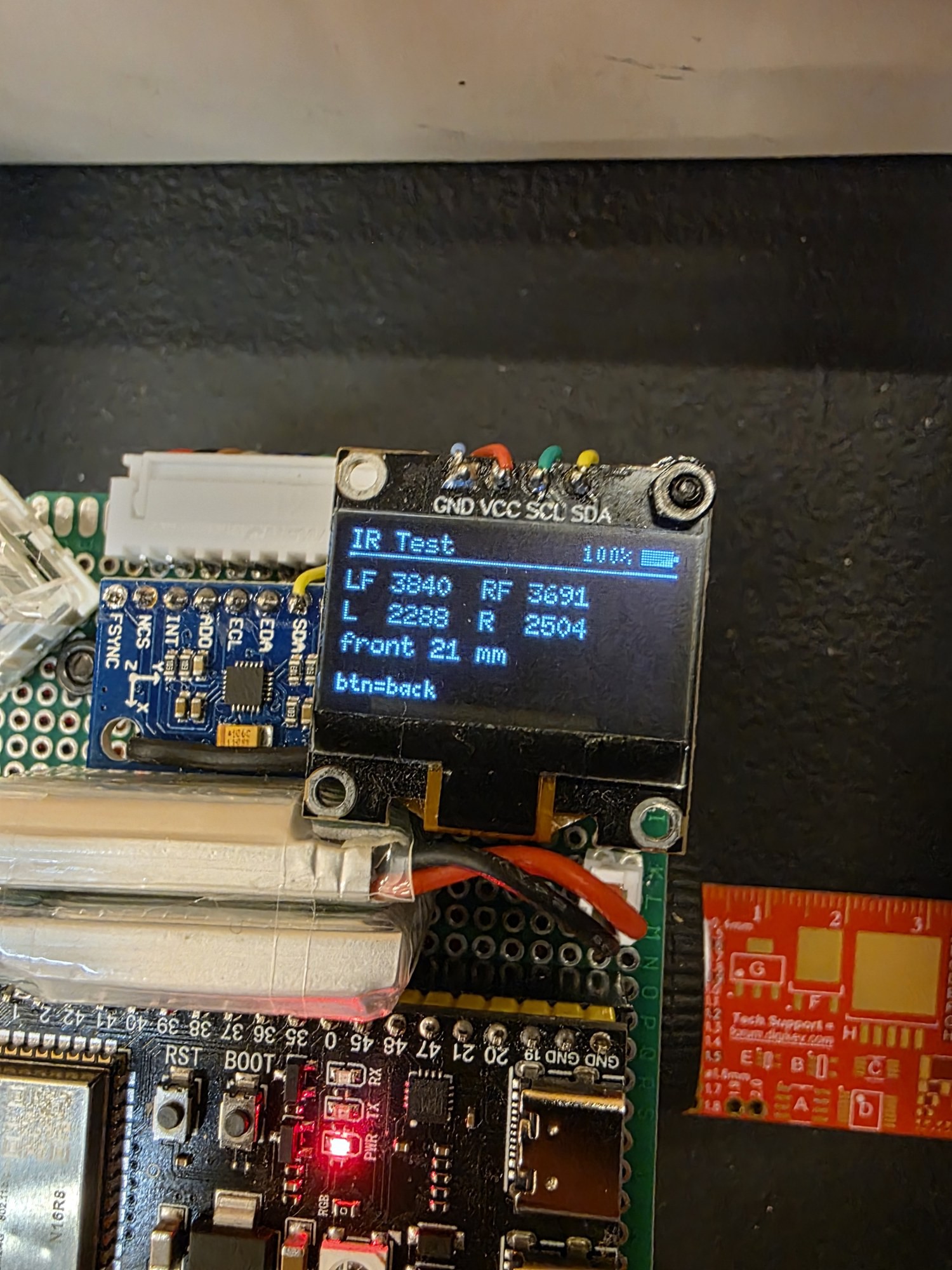Close-up of the hand-wired protoboard and OLED.